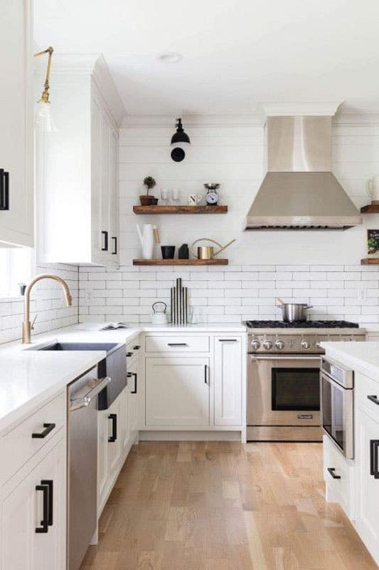 White Brick Backsplash with white shaker cabinets and Stainless Steel Appliances