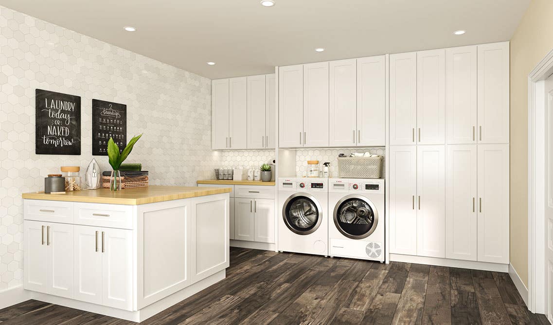 Laundry Room with Island, wood countertop, washer and dryer, and spc flooring