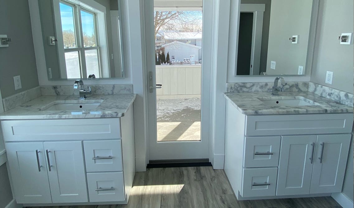 White shaker double vanity paired with marble countertop 
