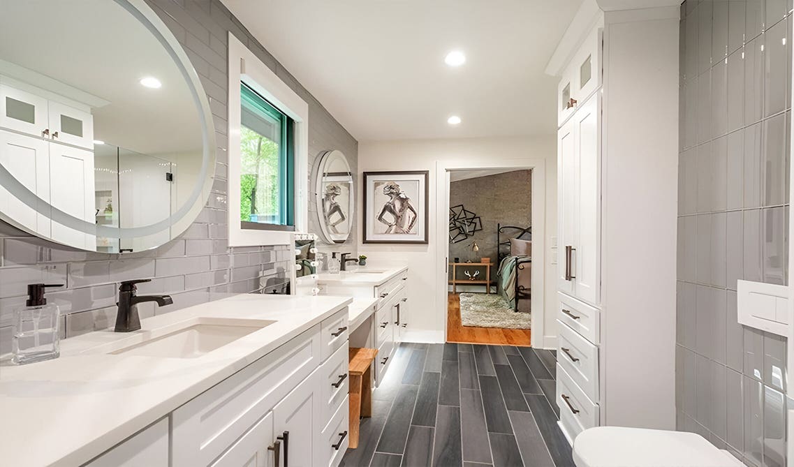 White and gray themed bathroom with double sink vanity and statement mirror