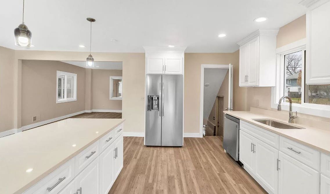 White cabinets with Butterfly Beige granite countertops