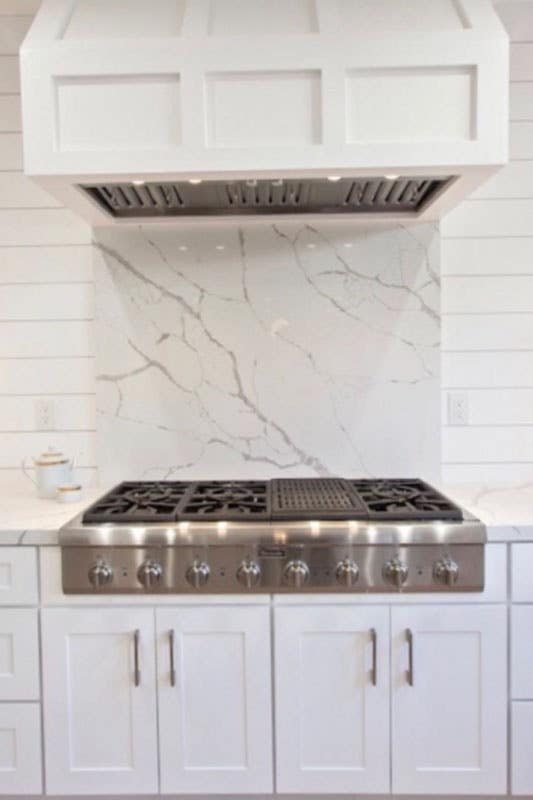 White kitchen with large slab of marble just above your stove