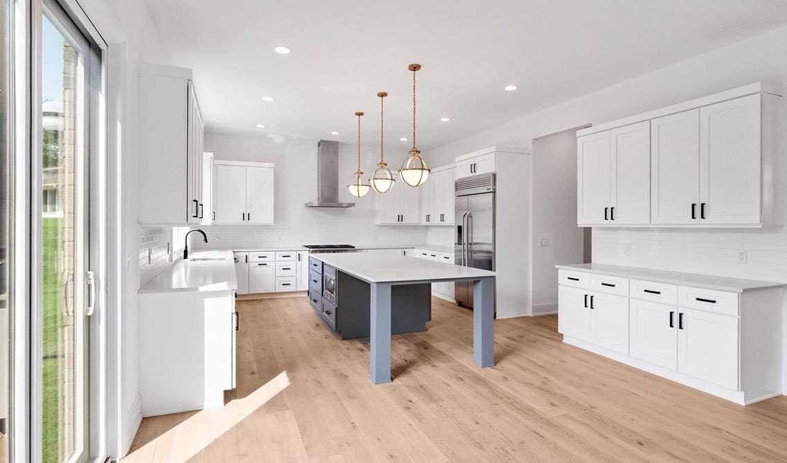 White themed kitchen with Colorado White Shaker Cabinets and wood flooring