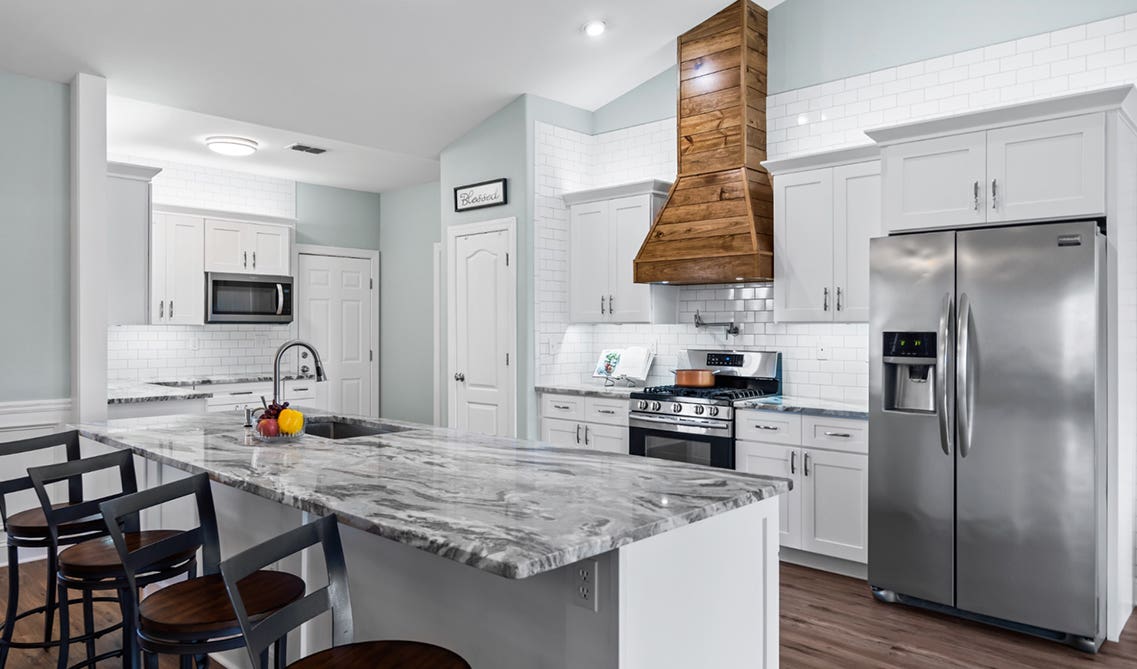 White traditional kitchen with wood accent and stainless steel appliances 