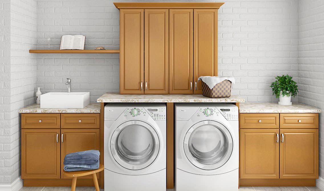 Laundry Room with wood cabinets, marble countertop, washer and dryer, and tile flooring