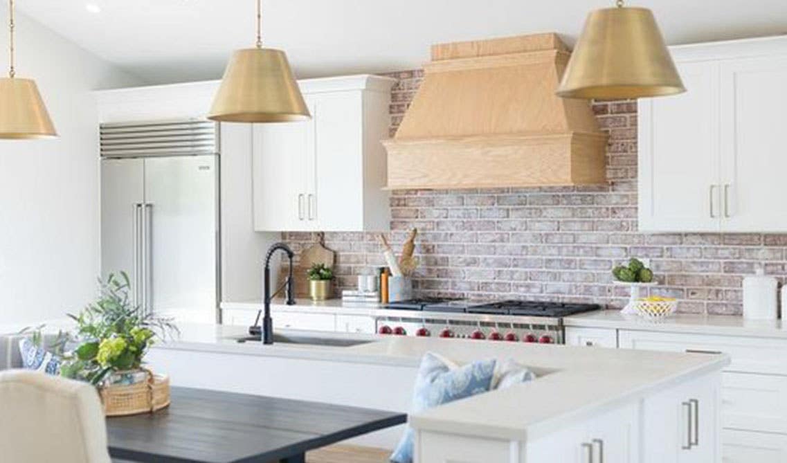 Painted Brick Backsplash with Wood Hood and bright white cabinets