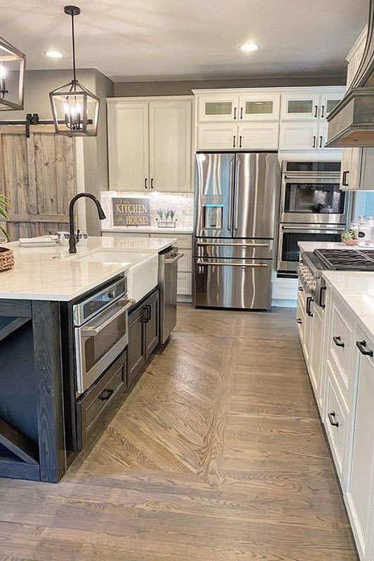 Navy blue island cabinets with white granite countertop