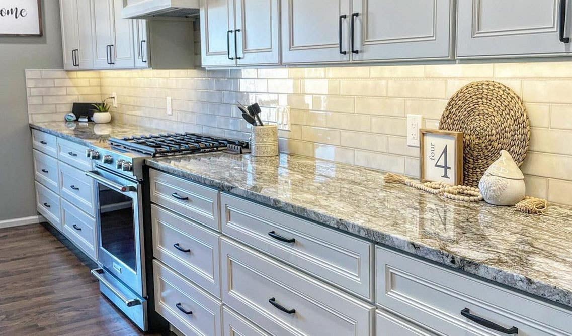 Kitchen Design with York Linen Kitchen Cabinets, quartz countertop and wooden flooring 