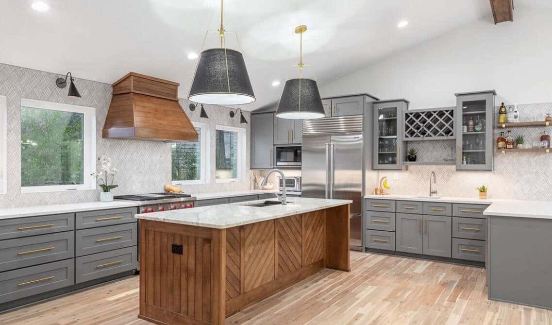 grey kitchen cabinets with white countertop and wooden island 