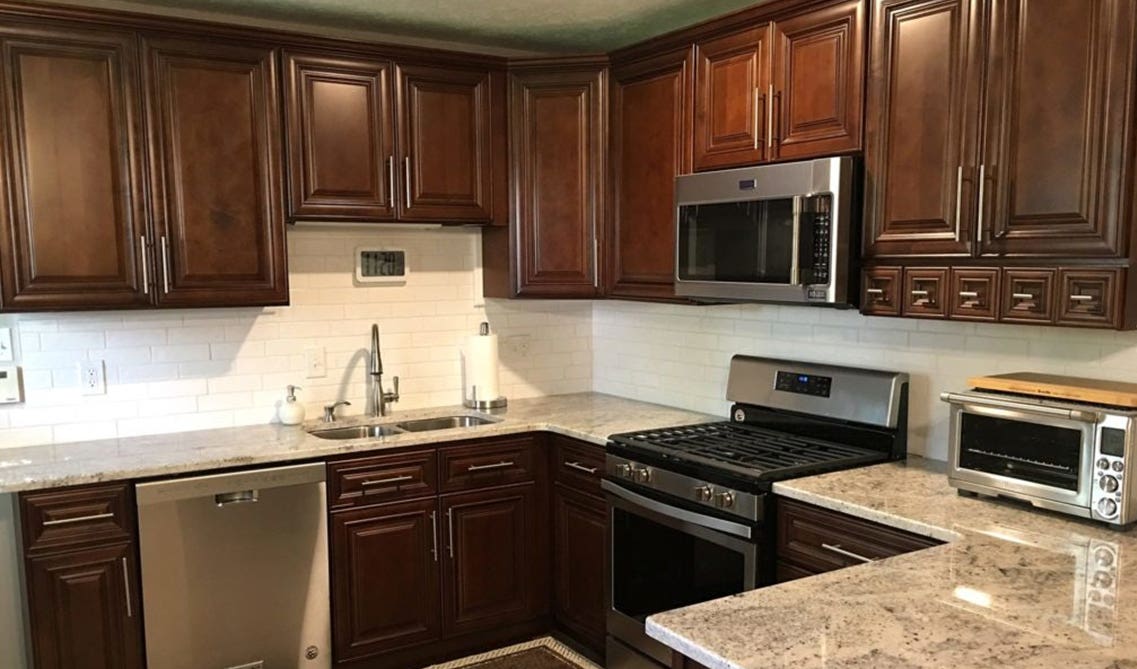 Bristol Chocolate cabinets with subway tile backsplash and stainless steel appliances 