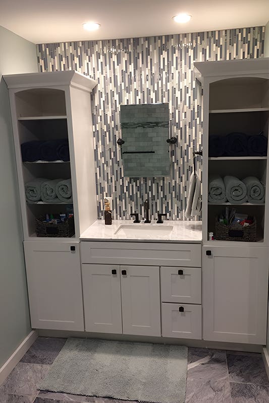 White cabinet built-in storage in bathroom