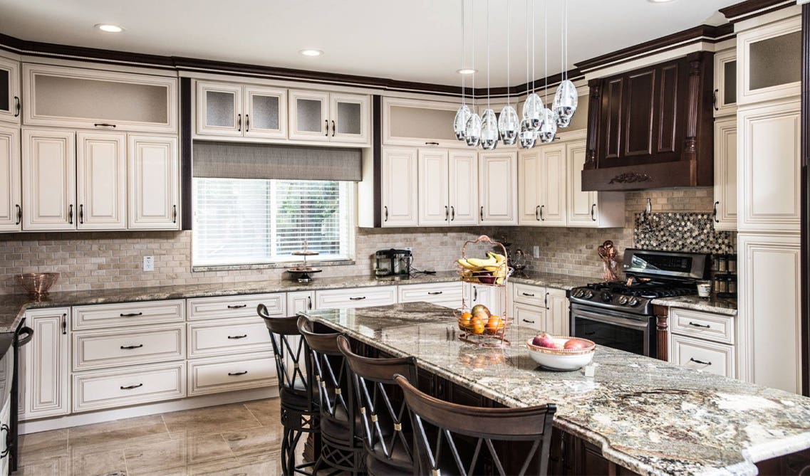 Classic kitchen design with traditional cabinets, decorative hardware, elegant moldings and marble countertops 