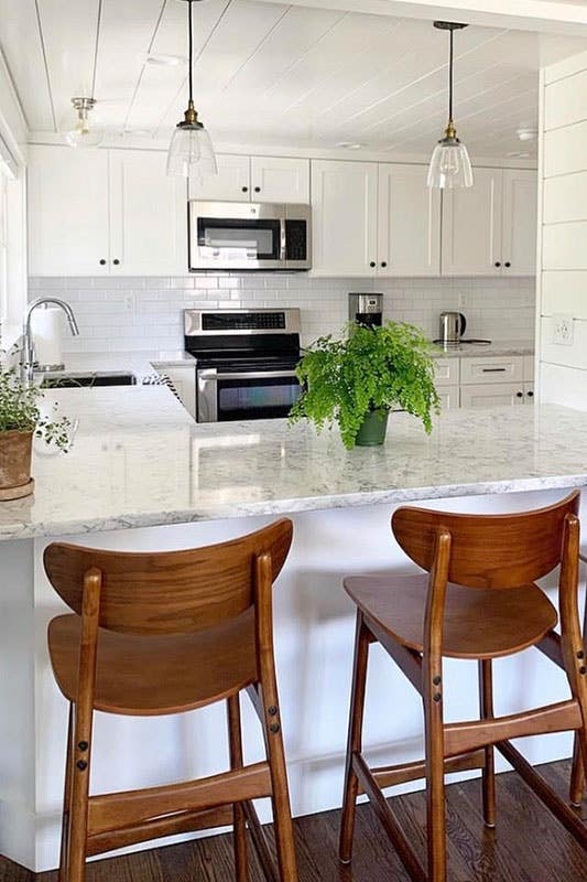 Coastal design kitchen with white cabinets and shiplap paneling 