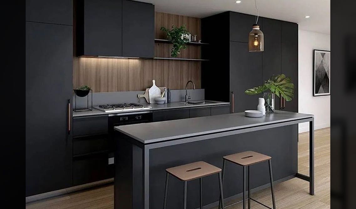 black cabinets with wooden wall and light gray countertop 