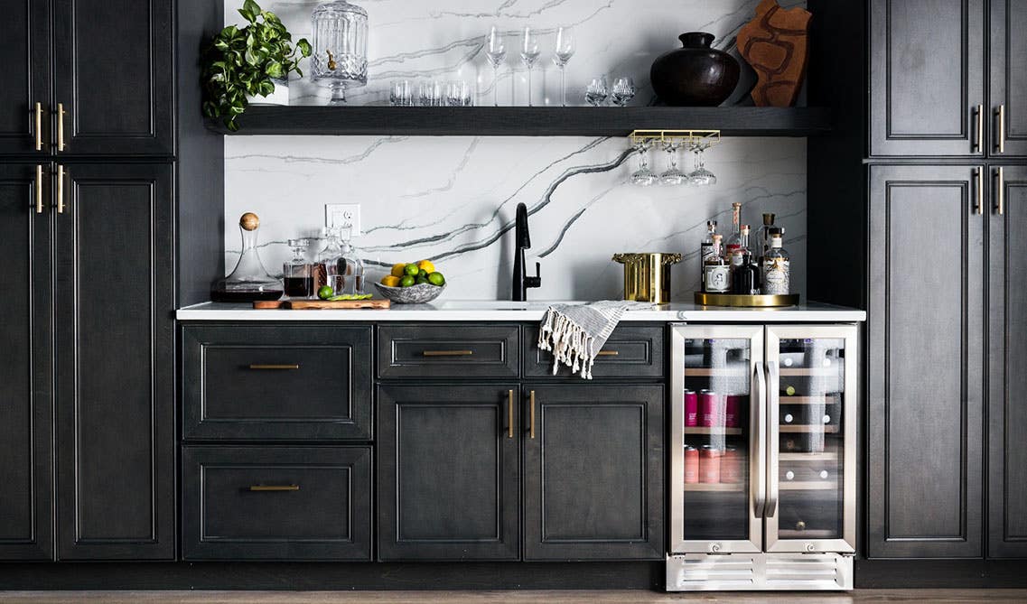 Darker tones kitchen with grey and white, with silver appliances.