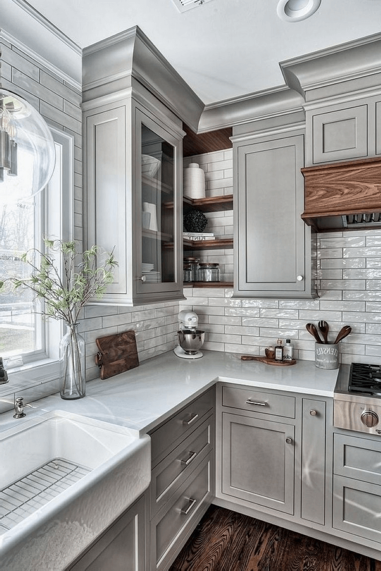 Grey stylish kitchen with white subway tile and ceramic sink