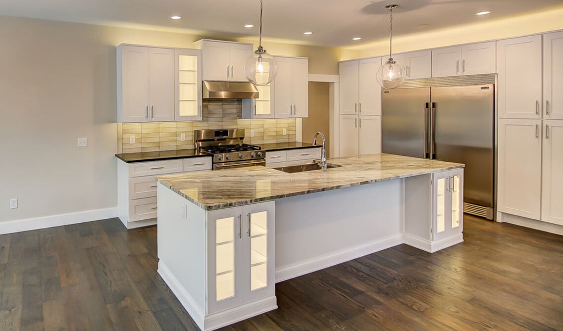 White kitchen cabinets paired with stainless steel appliances 