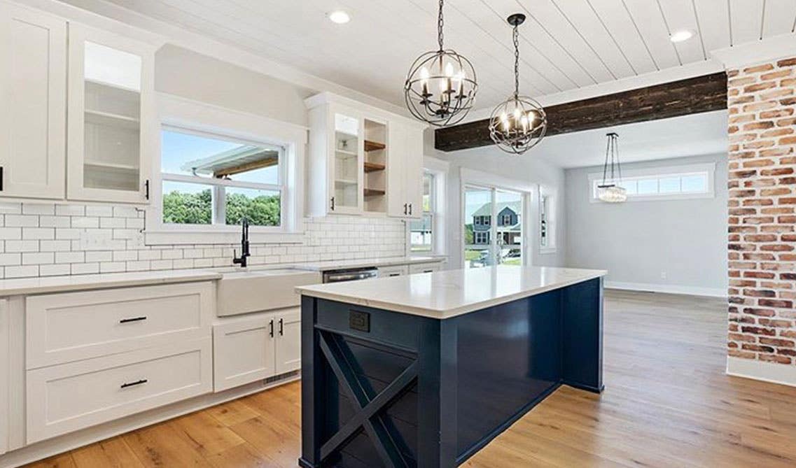 two-tone blue and white kitchen cabinets with Pedestal Sink and large island