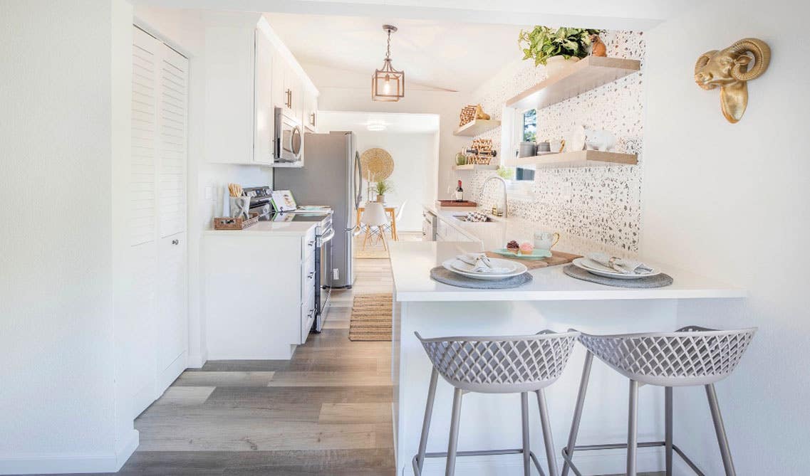 White themed Galley kitchen design with open shelves, Vinyl Flooring, and dining chair