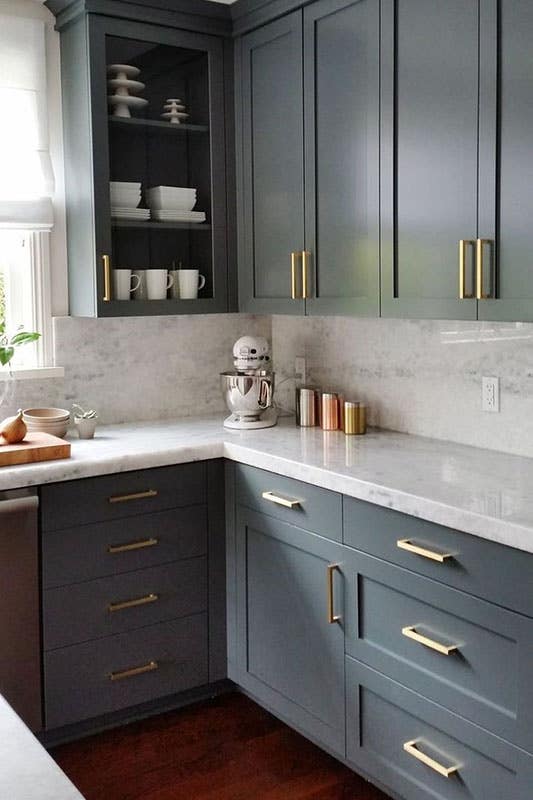 Grey cabinets design with white countertop and gold accent 