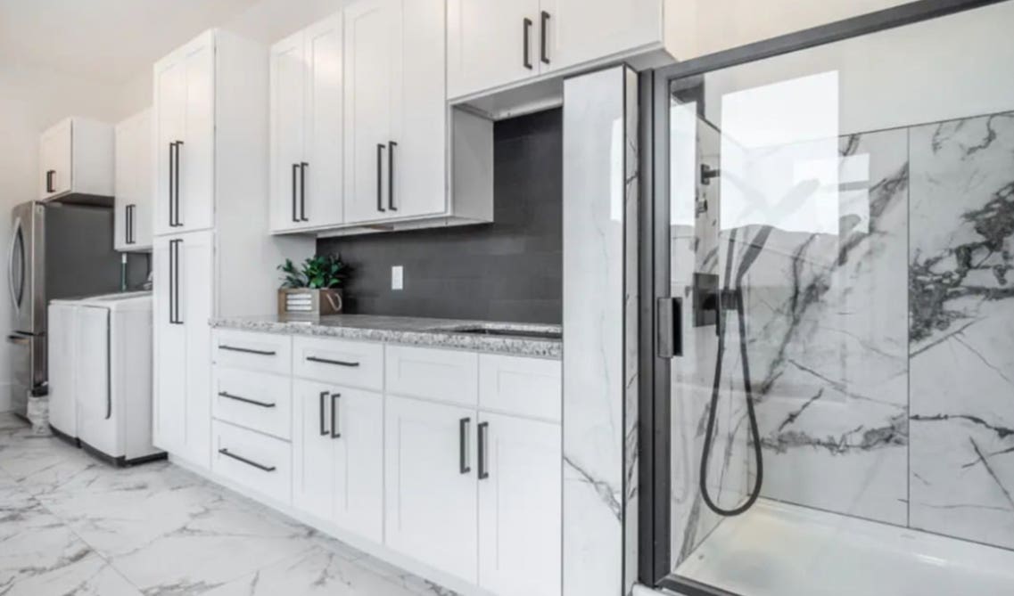 Bathroom with white vanity and black hardware 