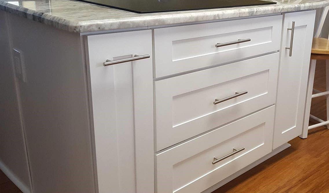 Shaker Cabinets with stainless steel hardware and marble countertop