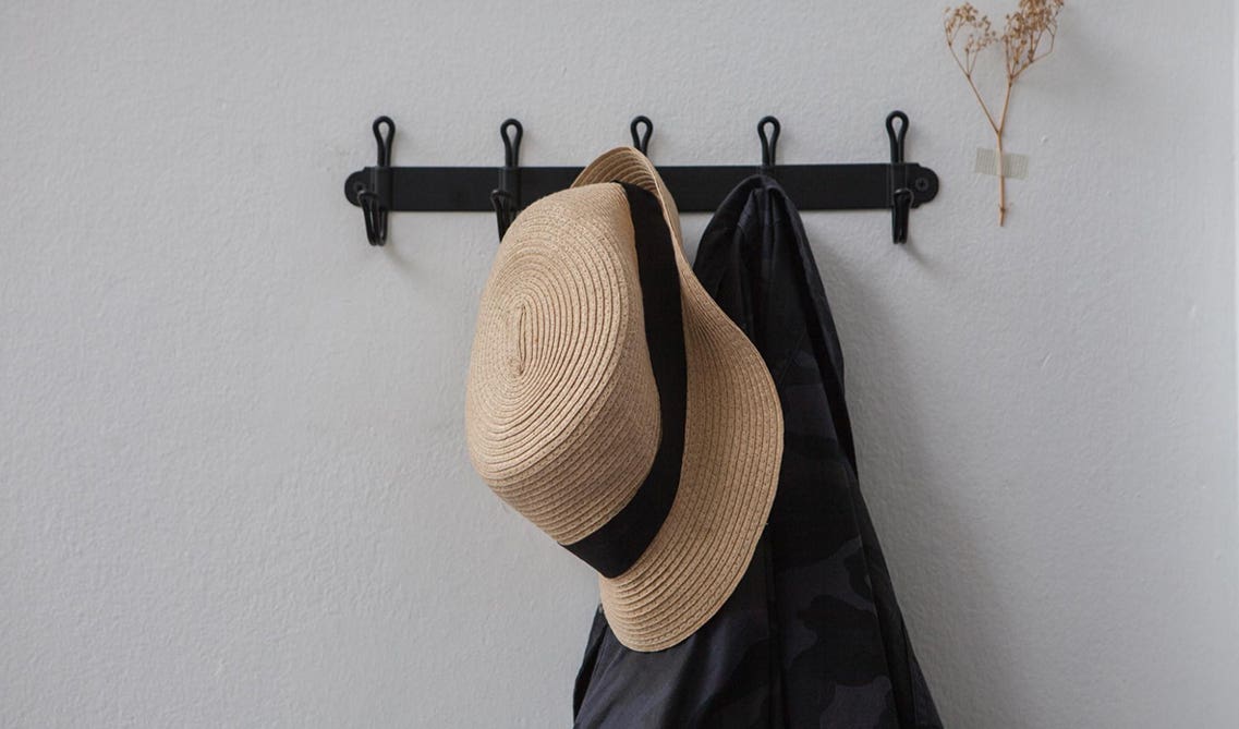 hat and dress hanged on hooks 