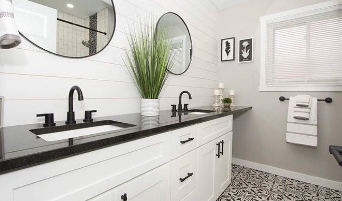 Picture white vanity with black countertop and large mirrors