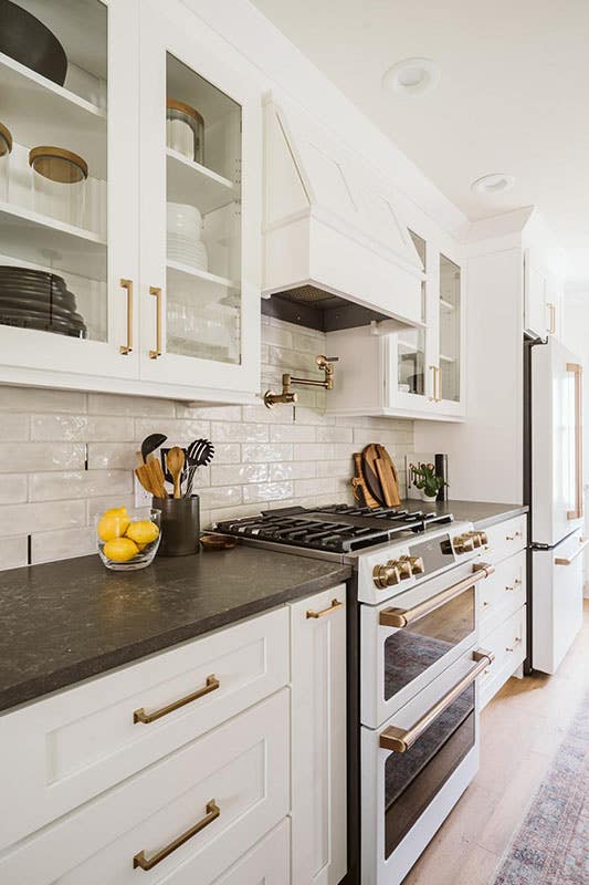 Rustic Small kitchen with shaker cabinets, black marble countertop and wood range hood