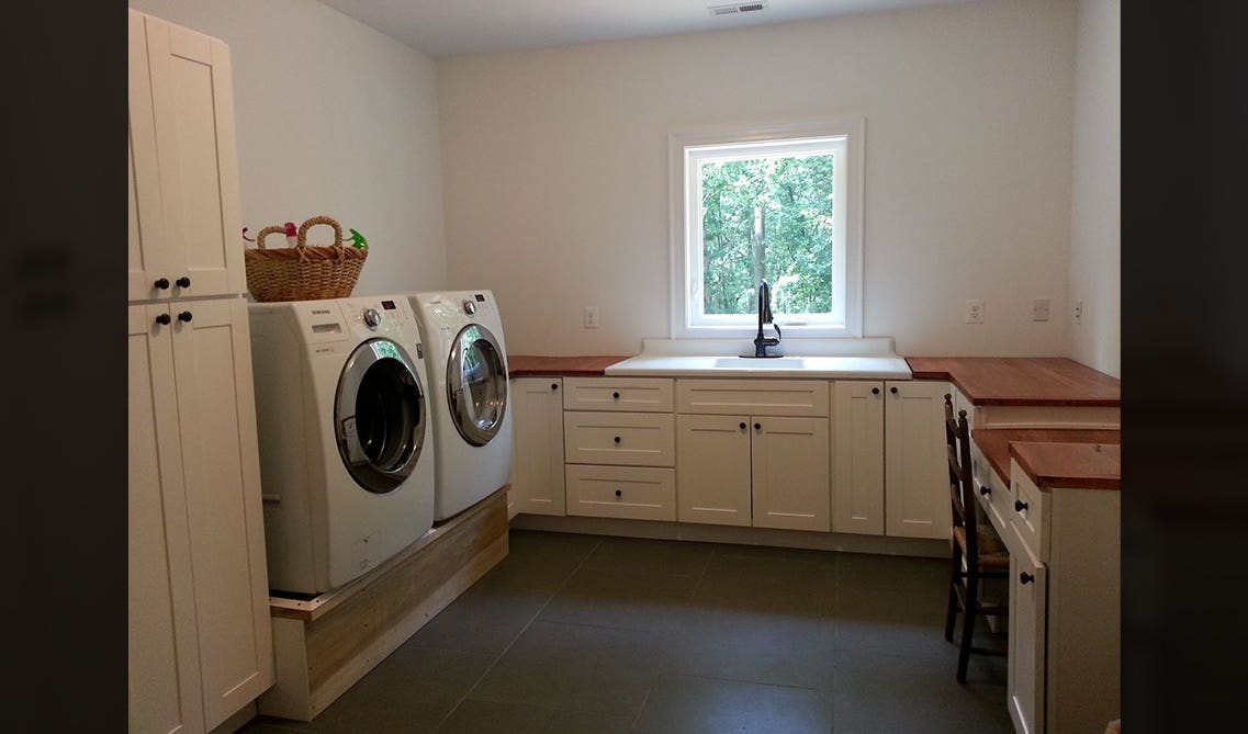 Laundry room cabinets with open wide window 