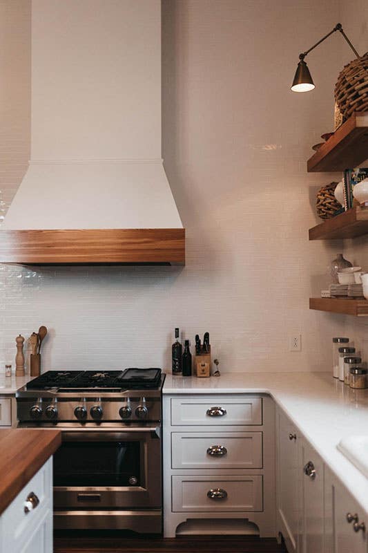 Rustic Kitchen with wood hood and floating shelves