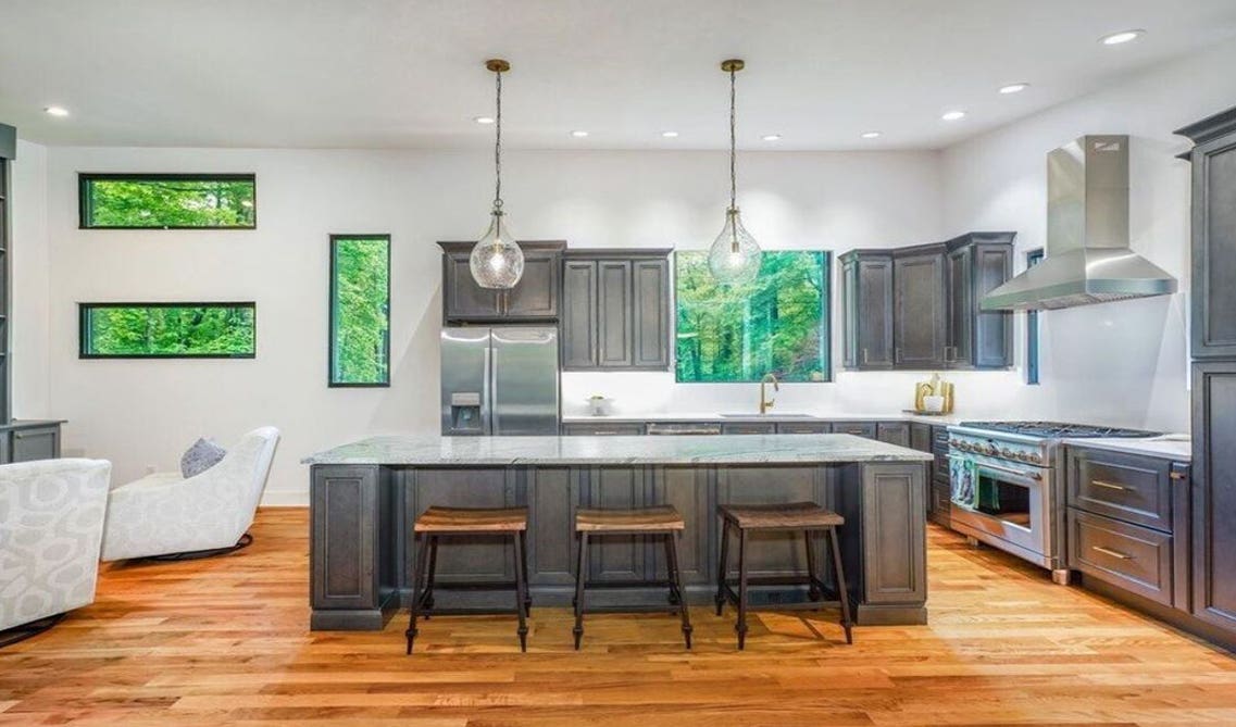 Grey theme kitchen design with wooden flooring 