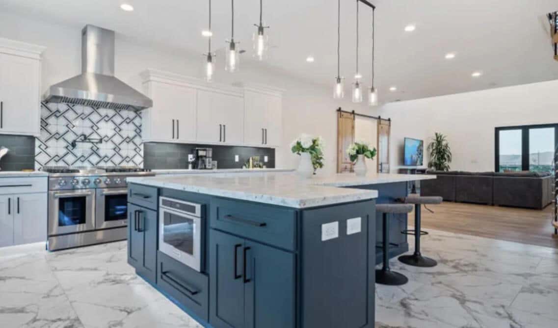 modern open kitchen with L shape island with marble countertop