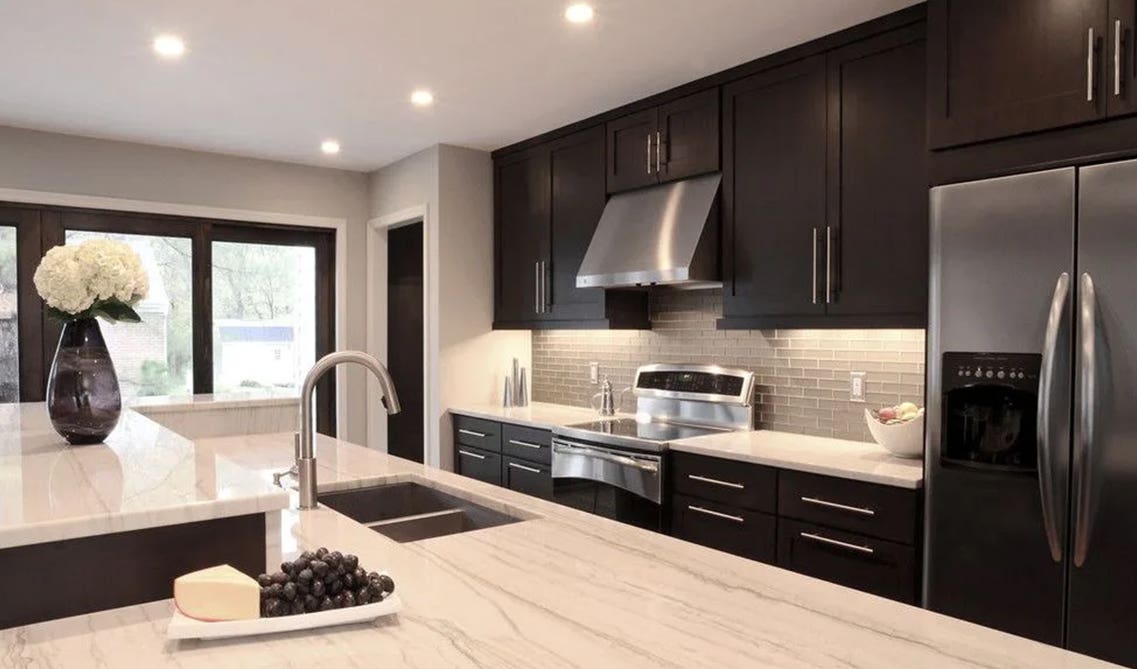  dark chocolate brown cabinets with mosaic tile backsplash and white wall paint