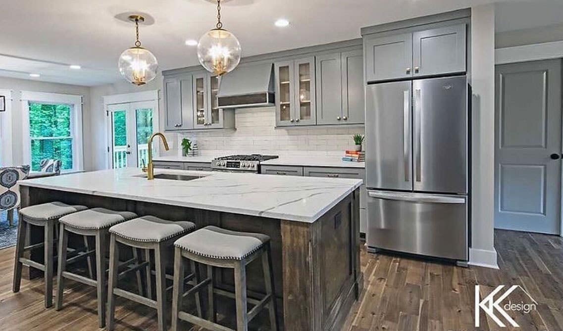 Luxury kitchen design with large island incorporated sink and seating stools