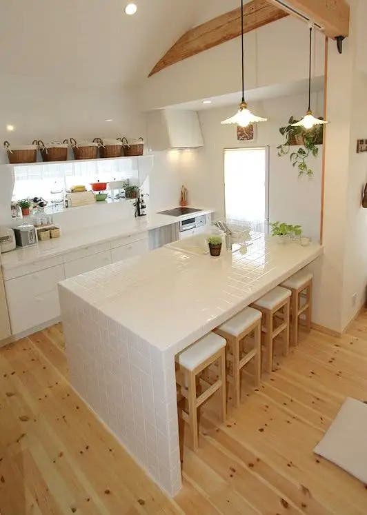 Tile waterfall countertops paired with white cabinets