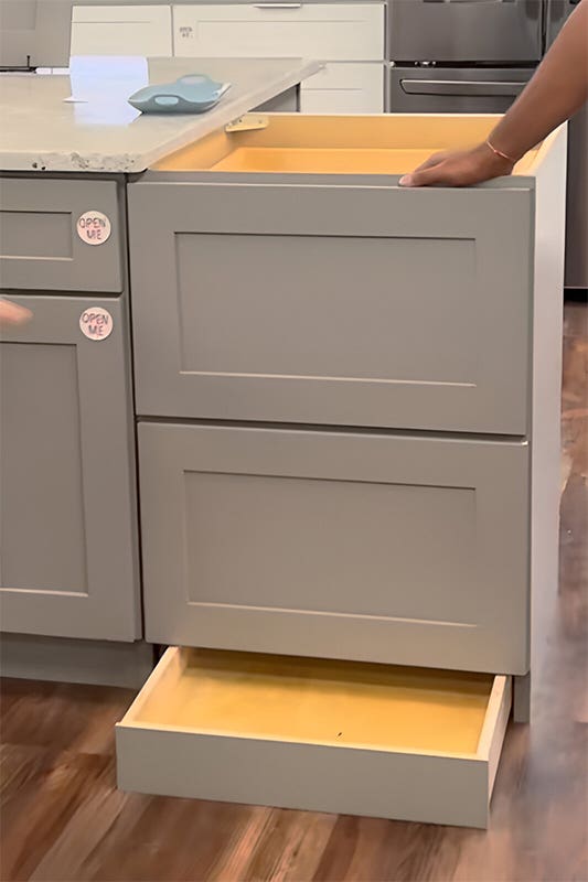 Toe kick drawer in gray base cabinet