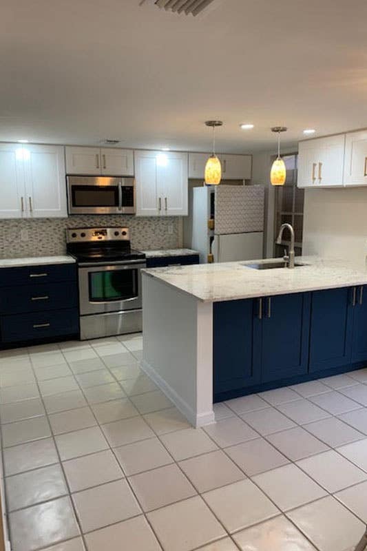 white shaker cabinets and blue island kitchen