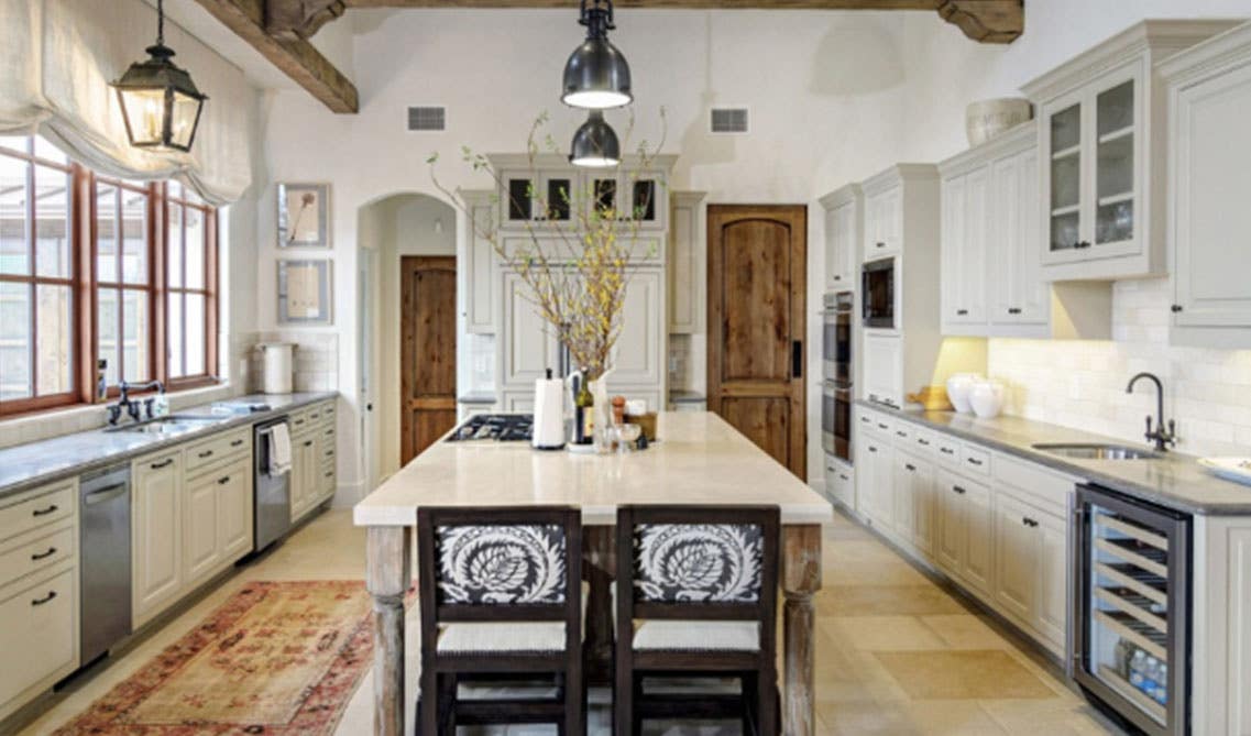 rustic kitchen open space with wood ceiling beams and oversized white kitchen island