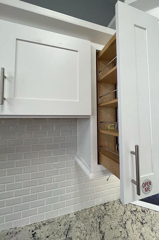 shaker white cabinet organizer and subway tile backsplash