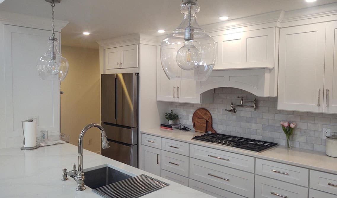 White shaker cabinets with large island with white countertop