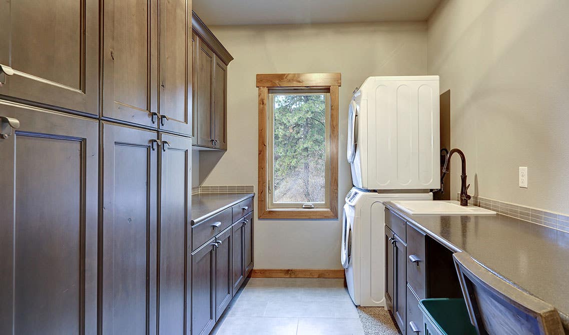 organised laundry room with cabinets for storage and washer and dryer