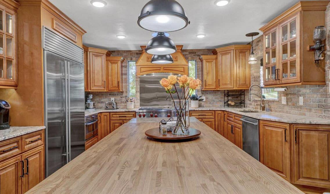 U shaped Brown kitchen with large island design 